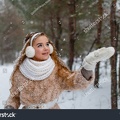 stock-photo-attractive-young-girl-in-wintertime-outdoor-a-girl-in-the-winter-forest-smiling-and-cheering-532164805.jpg