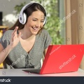 stock-photo-happy-woman-wearing-headphones-greeting-during-a-video-conference-on-line-with-a-red-laptop-sitting-567341227.jpg