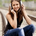 13665966-Teen-girl-with-headphones-at-railways--Stock-Photo.jpg