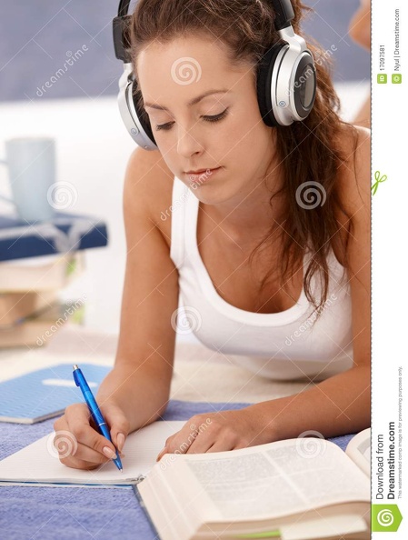 attractive-girl-writing-homework-laying-floor-17097581.jpg
