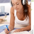attractive-girl-writing-homework-laying-floor-17097581