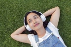 cute-indonesian-girl-with-headphones-laying-on-the-grass 1437-731