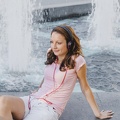 young-girl-in-headphones-posing-on-fountain 23-2147659360