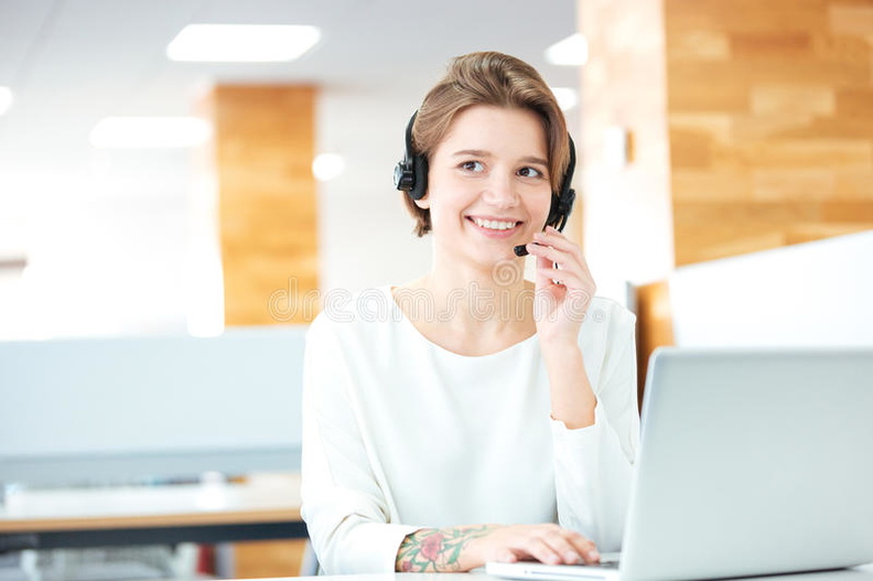 cheerful-attractive-young-woman-working-headset-laptop-sitting-call-center-office-67141336