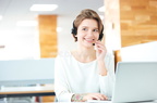 cheerful-attractive-young-woman-working-headset-laptop-sitting-call-center-office-67141336