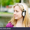 woman-with-headphones-by-canal-E5WP30