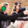 woman-green-ear-protection-at-range