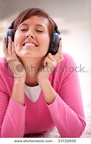 stock-photo-beautiful-girl-smiling-and-listening-to-music-with-headphones-33722935