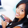 bigstock-39907063-closeup-portrait-of-a-young-asian-woman-in-headphones-listening-to-music-with-her-smartphone