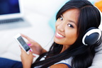 bigstock-39907063-closeup-portrait-of-a-young-asian-woman-in-headphones-listening-to-music-with-her-smartphone