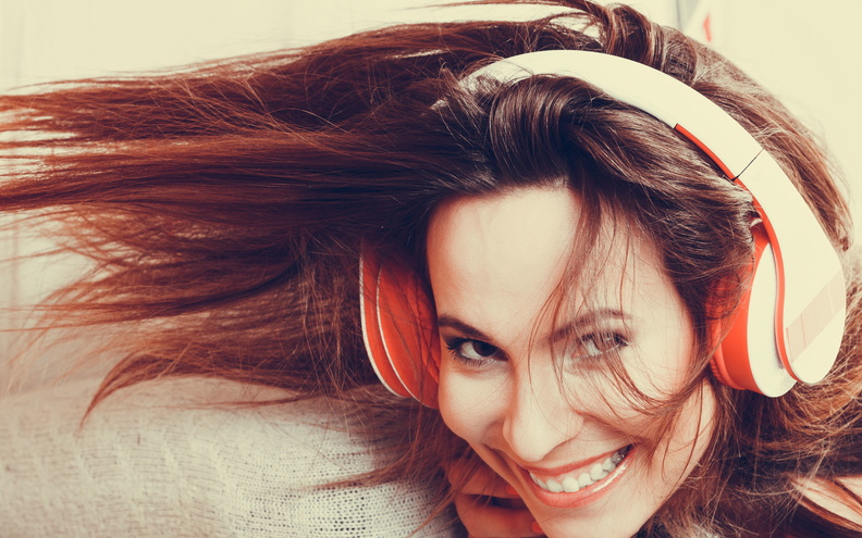bigstock-Woman-With-Headphones-Listenin-83457878