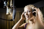 Blonde woman wearing AKG K240 headphones in recording studio