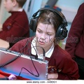 female-primary-school-children-learning-languages-with-headphones-a49dg1