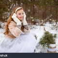 stock-photo-attractive-young-girl-in-wintertime-outdoor-a-girl-in-the-winter-forest-smiling-and-cheering-532164709