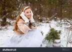 stock-photo-attractive-young-girl-in-wintertime-outdoor-a-girl-in-the-winter-forest-smiling-and-cheering-532164709