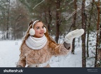 stock-photo-attractive-young-girl-in-wintertime-outdoor-a-girl-in-the-winter-forest-smiling-and-cheering-532164805
