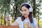 indonesian-girl-listening-music-with-headphones-and-smart-phone 1437-673