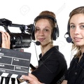 28796635-two-young-women-with-a-video-camera-and-a-clapper-board-Stock-Photo