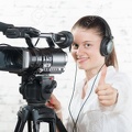 45555120-a-pretty-young-woman-with-a-professional-camera-Stock-Photo