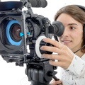 68354943-beautiful-young-woman-with-DSLR-video-camera-and-headphones-Stock-Photo