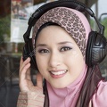 10407380-young-muslim-girl-smile-with-headphones--Stock-Photo