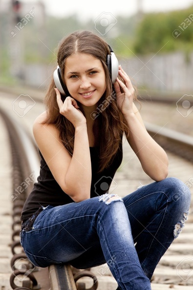 13665966-Teen-girl-with-headphones-at-railways--Stock-Photo.jpg
