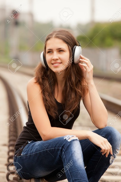 18342331-Teen-girl-with-headphones-at-railways--Stock-Photo.jpg