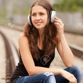 18342331-Teen-girl-with-headphones-at-railways--Stock-Photo