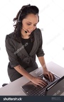 stock-photo-a-business-woman-working-on-her-computer-with-her-headset-on-44382877