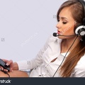 stock-photo-attractive-woman-with-headset-on-a-gray-background-84661342.jpg