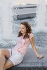young-girl-in-headphones-posing-on-fountain 23-2147659360