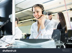 stock-photo-smiling-agent-woman-with-headsets-portrait-of-call-center-worker-at-office-592555262