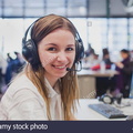 happy-student-with-headphones-and-computer-in-university-F587J2