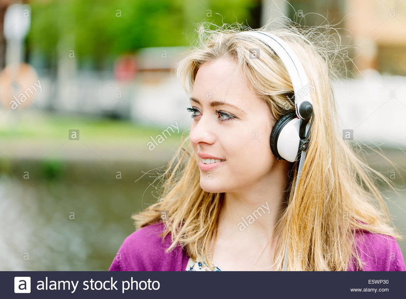 woman-with-headphones-by-canal-E5WP30.jpg