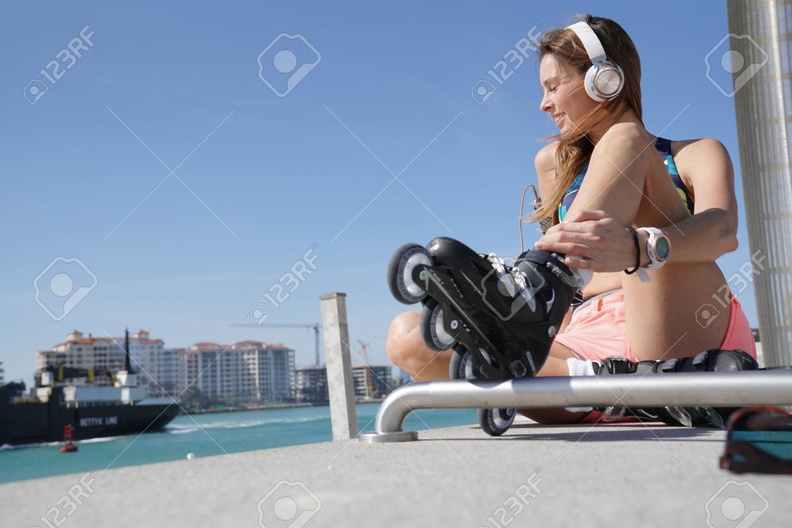 94546237-roller-skater-relaxing-and-listening-to-music-with-headphones.jpg