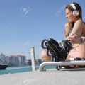 94546237-roller-skater-relaxing-and-listening-to-music-with-headphones