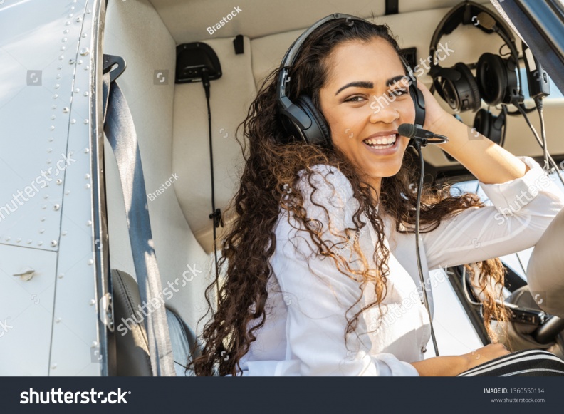 stock-photo-young-smiling-woman-helicopter-pilot-1360550114.jpg