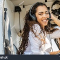 stock-photo-young-smiling-woman-helicopter-pilot-1360550114