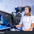 stock-photo-a-female-cameraman-at-a-studio-during-live-broadcasting-58015504