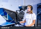 stock-photo-a-female-cameraman-at-a-studio-during-live-broadcasting-58015504