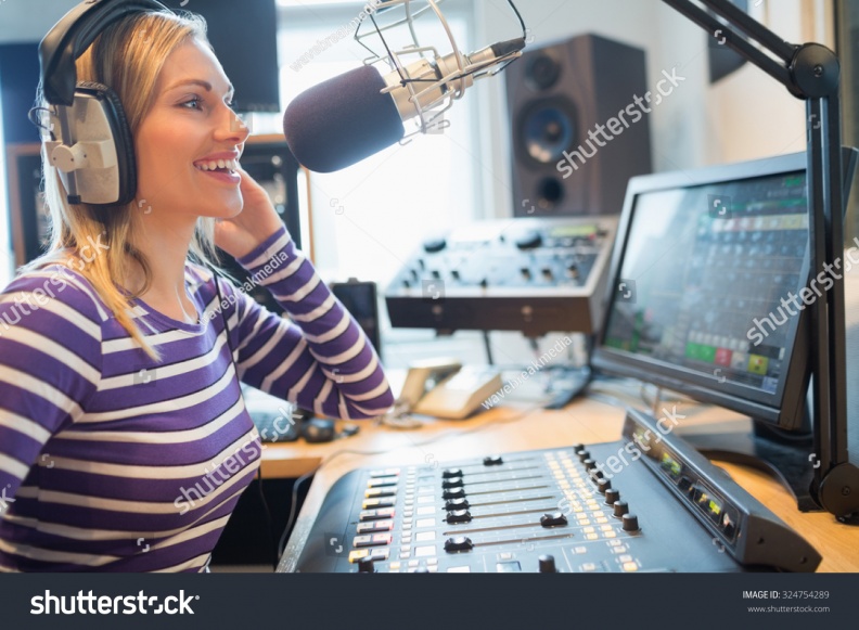 stock-photo-close-up-of-happy-female-radio-host-broadcasting-through-microphone-in-studio-324754289