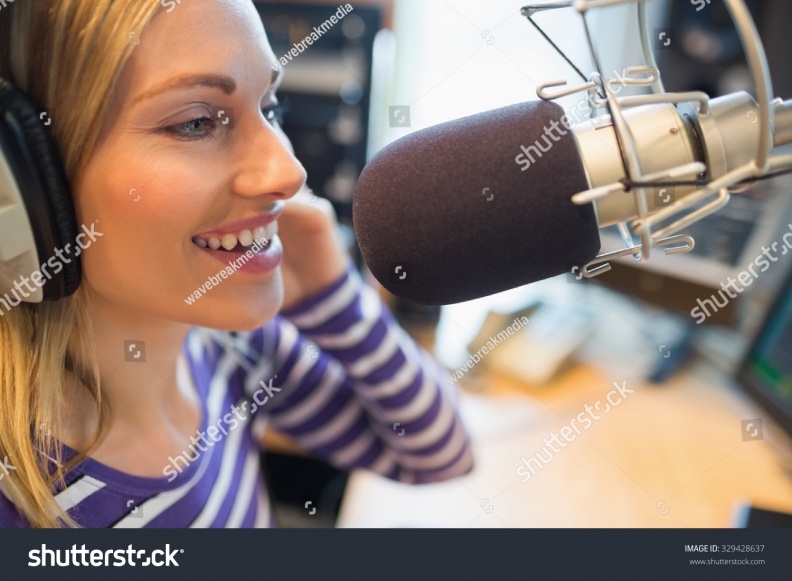stock-photo-close-up-of-happy-young-female-radio-host-broadcasting-in-studio-329428637.jpg