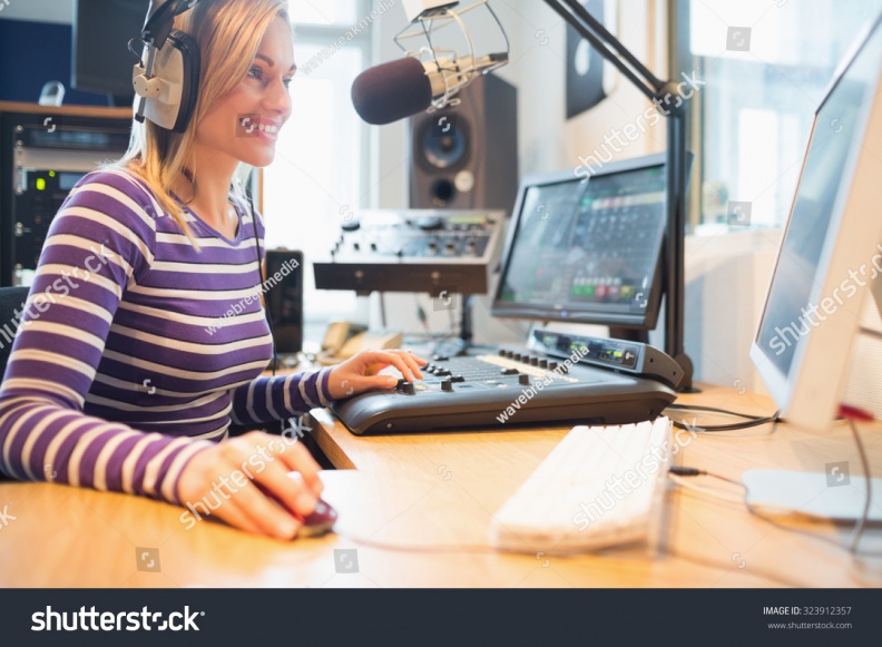 stock-photo-happy-female-radio-host-using-computer-while-broadcasting-in-studio-323912357.jpg