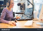 stock-photo-happy-female-radio-host-using-computer-while-broadcasting-in-studio-323912357