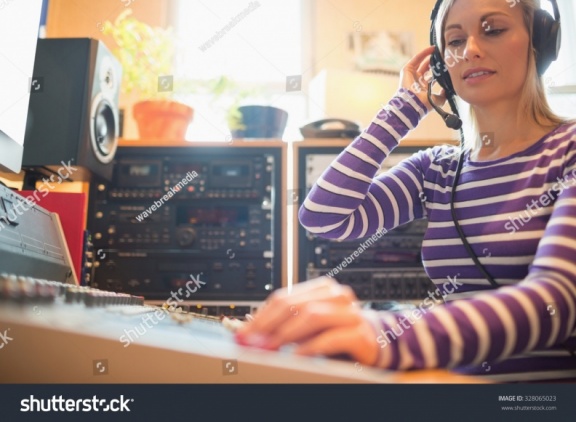 stock-photo-low-angle-view-of-young-radio-host-using-sound-mixer-in-studio-328065023