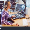 stock-photo-side-view-of-female-radio-host-broadcasting-through-microphone-in-studio-324754037