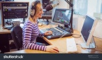 stock-photo-side-view-of-female-radio-host-broadcasting-through-microphone-in-studio-324754037