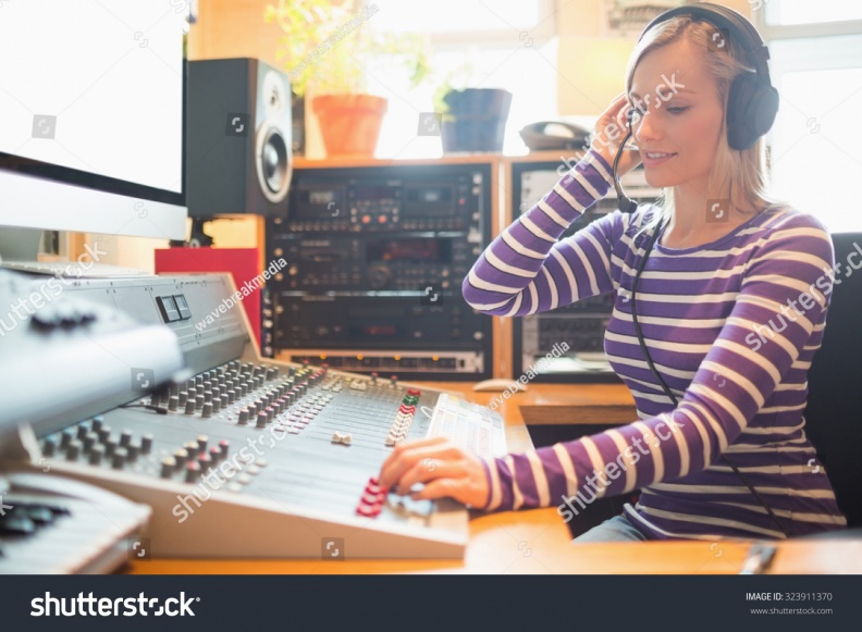 stock-photo-young-radio-host-wearing-headphones-using-sound-mixer-in-studio-323911370.jpg