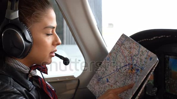 stock-footage-beautiful-young-woman-pilot-talking-over-headset-communication-device-with-air-traffic-controller