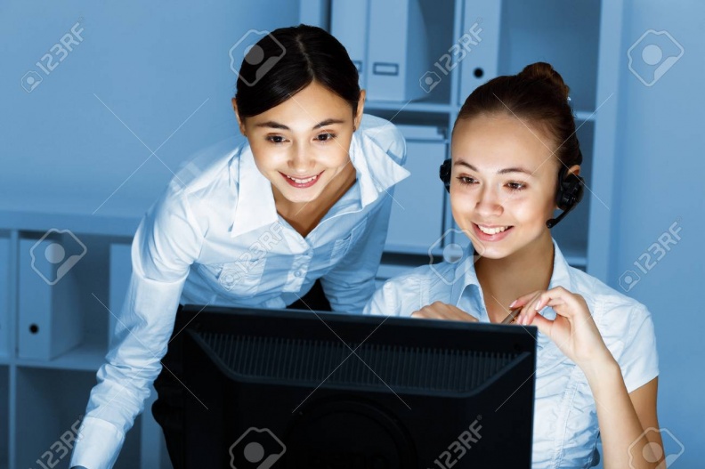 13383002-young-woman-in-business-wear-in-headset-working-with-computer.jpg